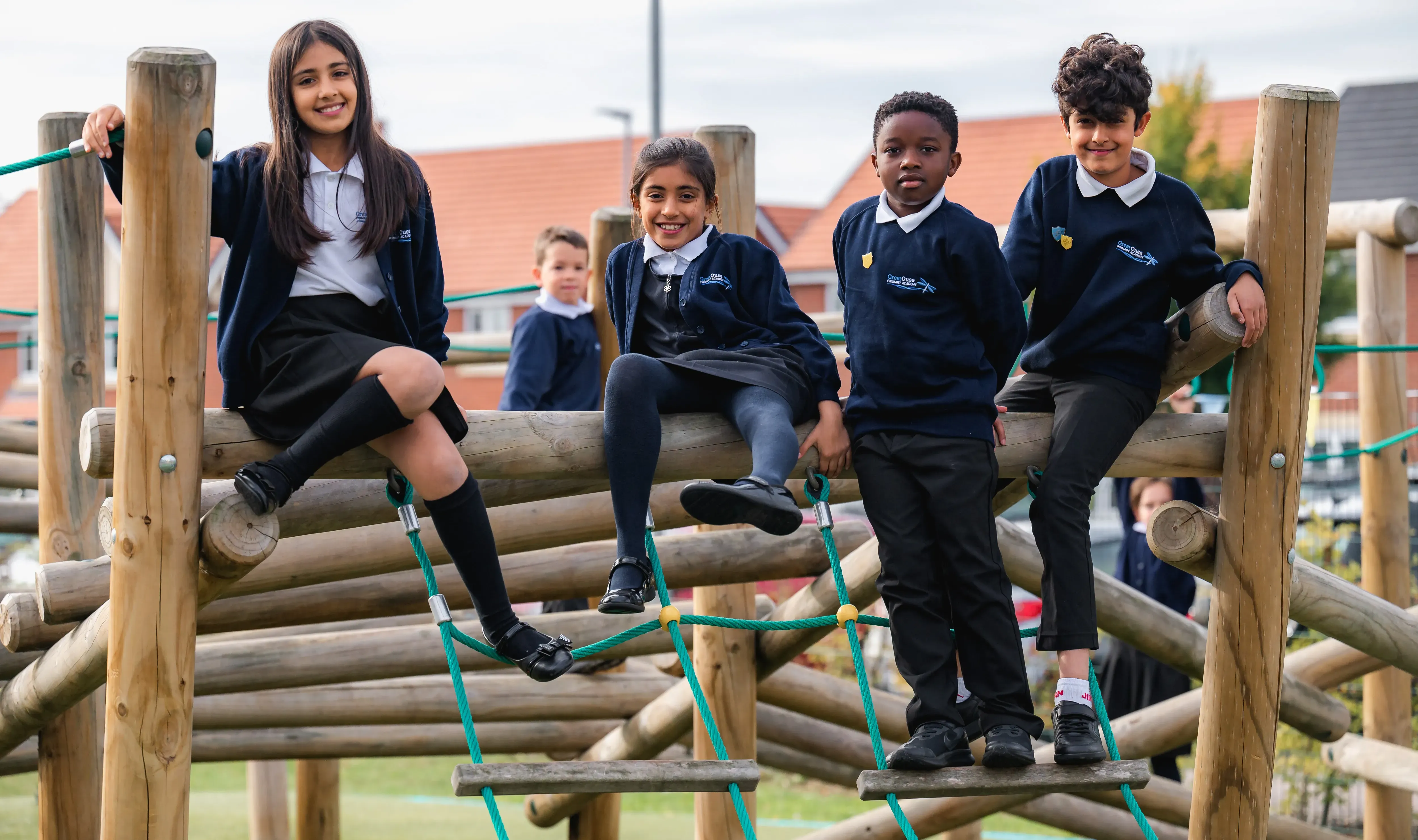 Students sitting on playground equipment